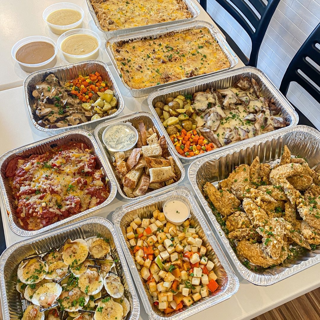 Full catering spread with multiple dishes and sides